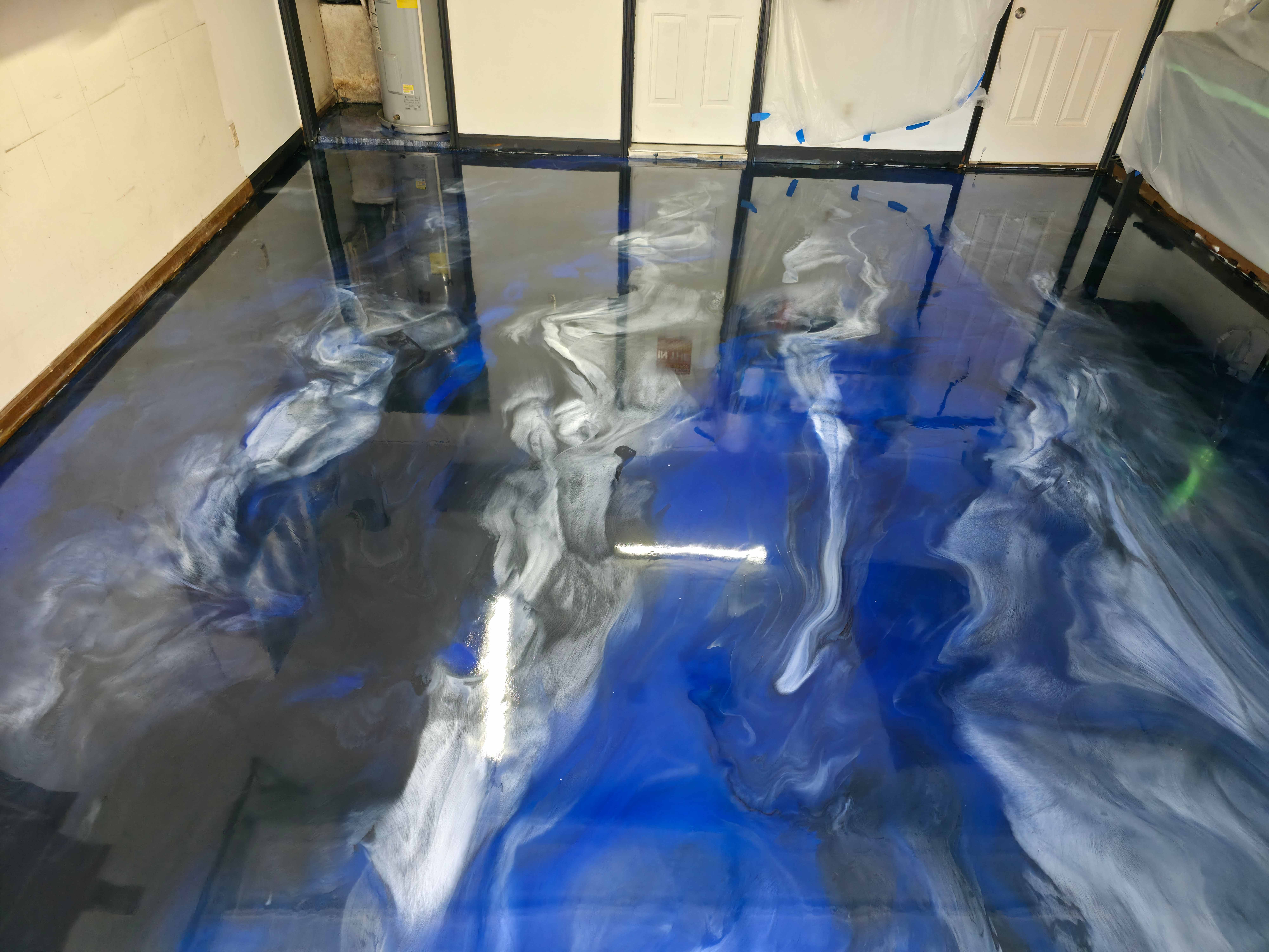 Beautiful metallic epoxy floor with blue and silver swirls